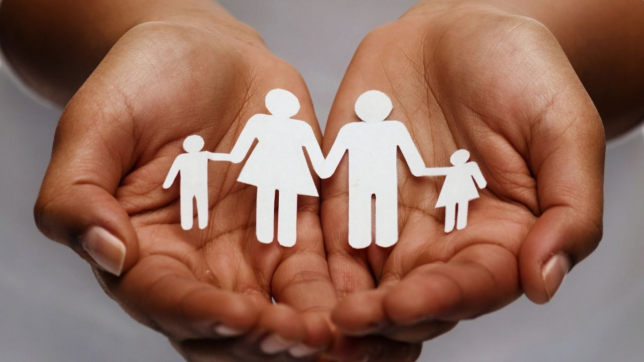 hands holding paper family cutout