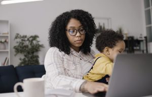 Mother at computer with baby