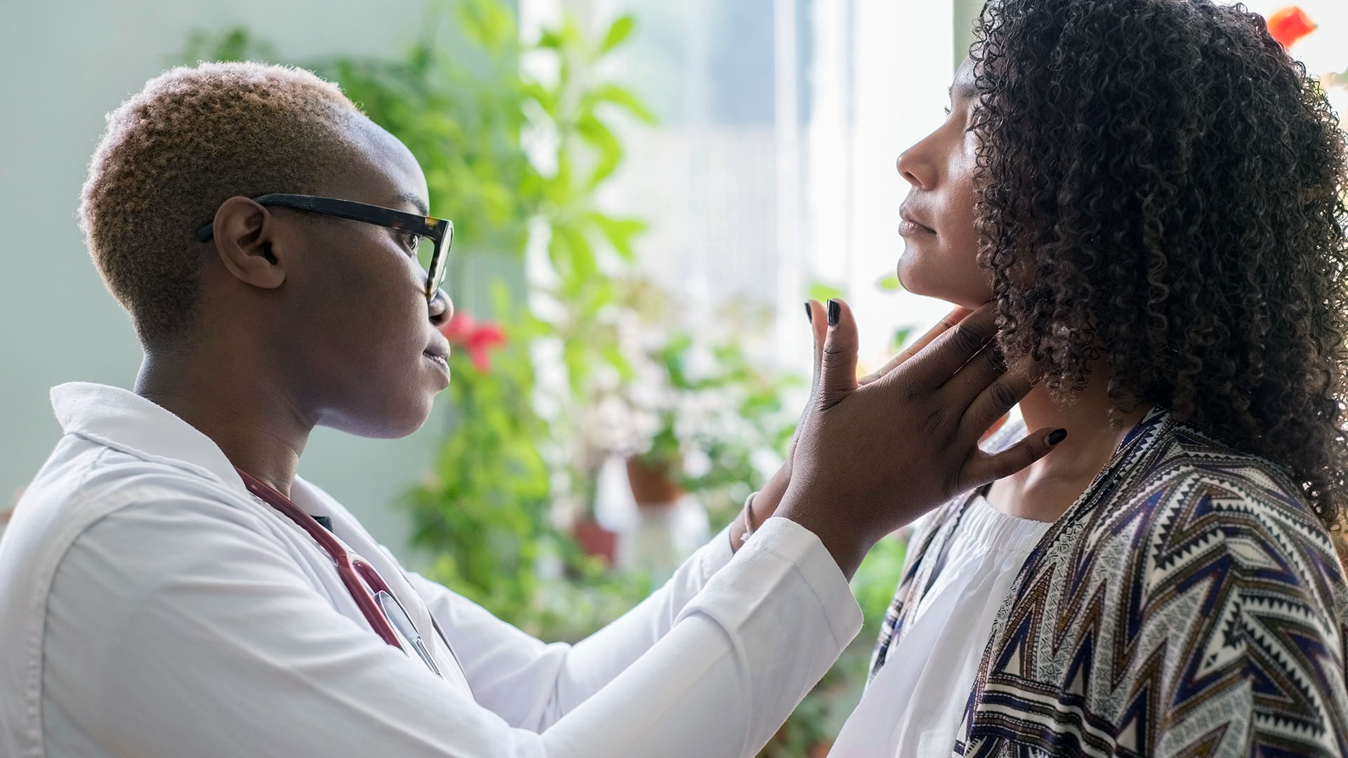 Black female doctor with patient