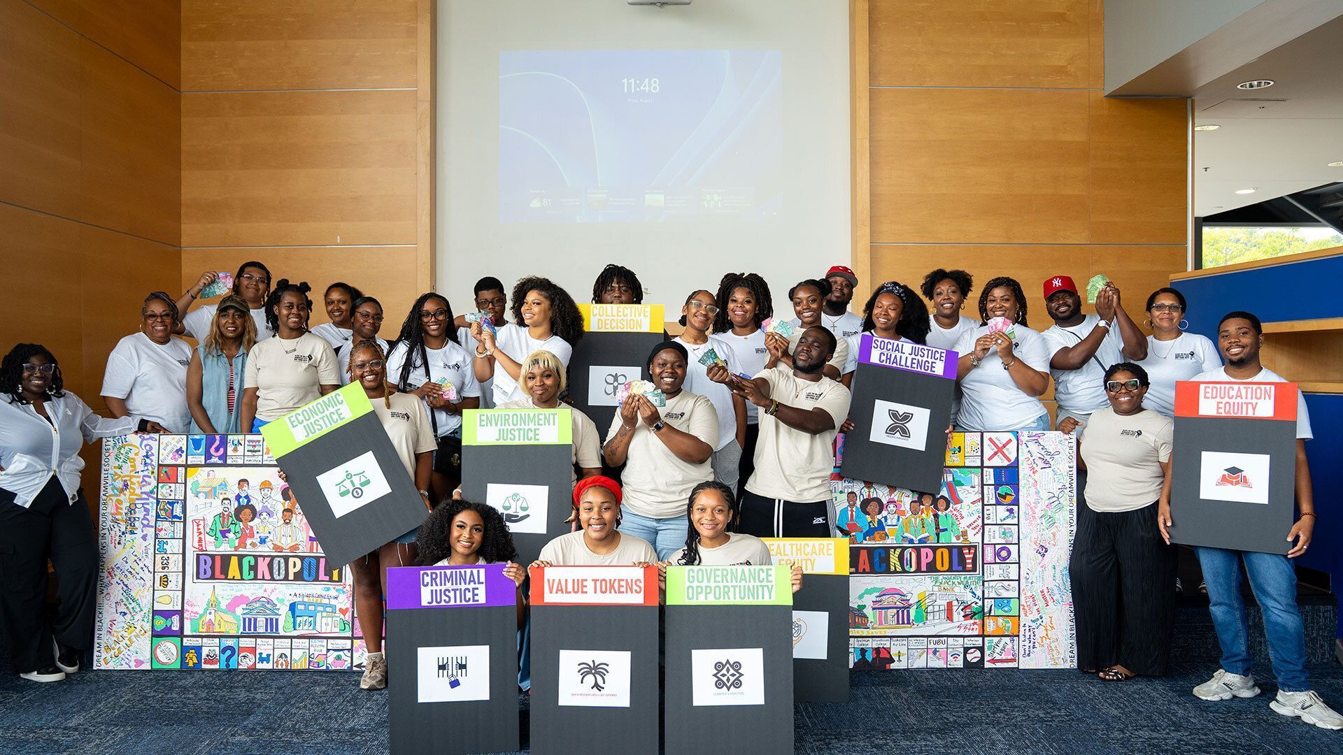 HBCU Think Tank students holding Blackopoly pieces